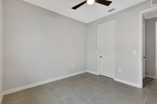521 SE Plumeria Dr, Port Saint Lucie, FL 34984 - unfurnished bedroom featuring tile patterned flooring and a ceiling fan