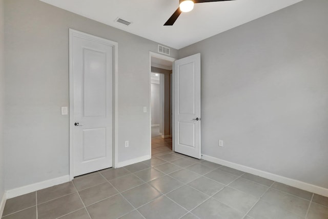 521 SE Plumeria Dr, Port Saint Lucie, FL 34984 - unfurnished bedroom with tile patterned flooring and a ceiling fan