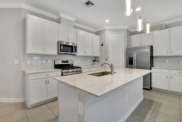 521 SE Plumeria Dr, Port Saint Lucie, FL 34984 - kitchen with appliances with stainless steel finishes, light tile patterned flooring, white cabinets, ornamental molding, and recessed lighting