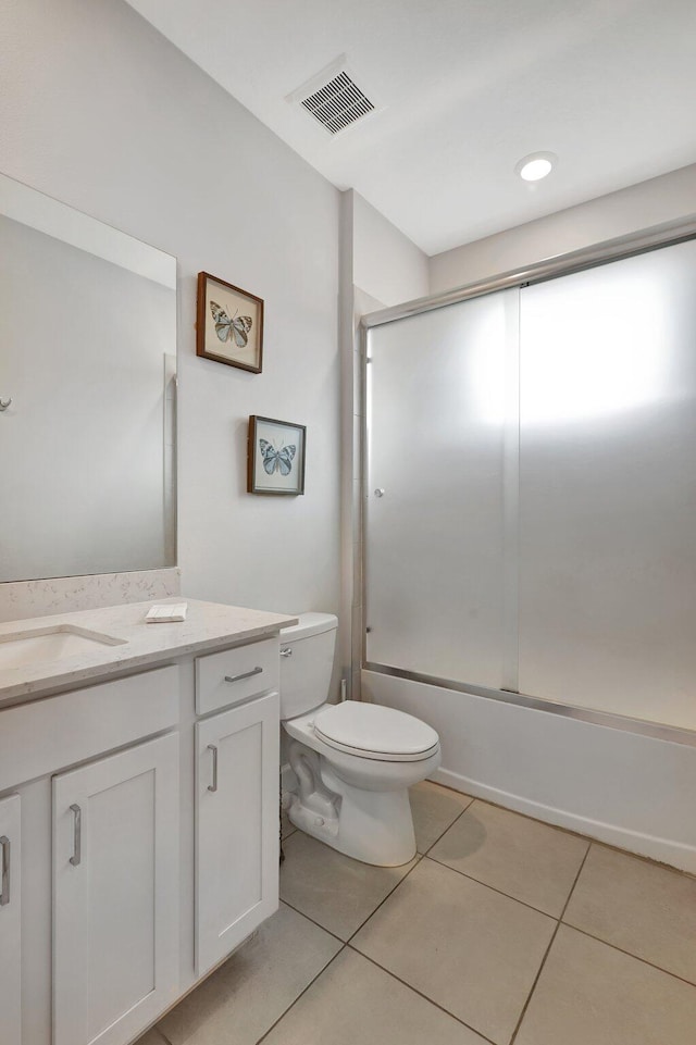 521 SE Plumeria Dr, Port Saint Lucie, FL 34984 - full bathroom with vanity, bath / shower combo with glass door, and tile patterned flooring