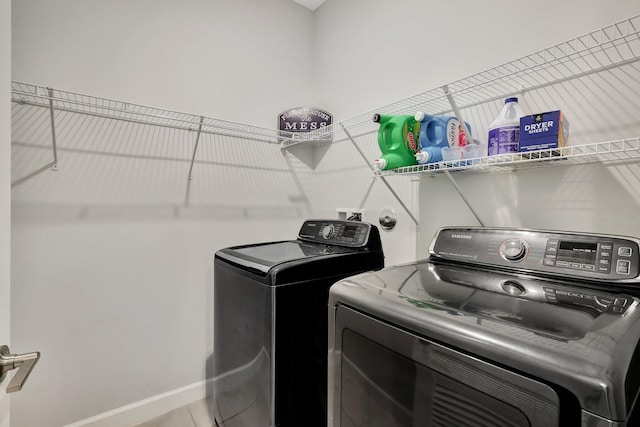 521 SE Plumeria Dr, Port Saint Lucie, FL 34984 - laundry area with washer and dryer and baseboards