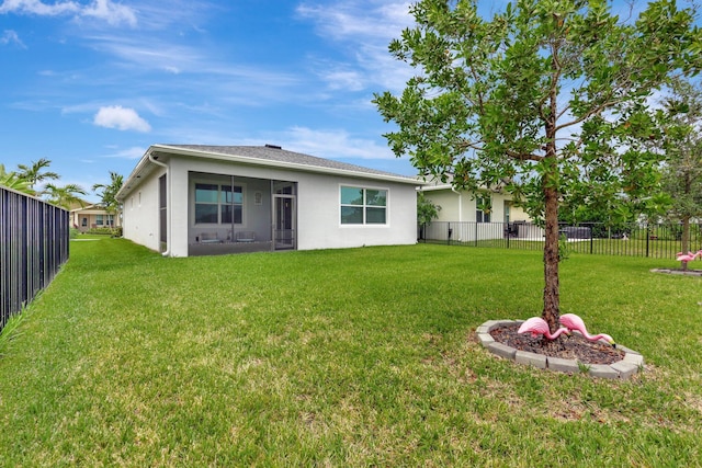 521 SE Plumeria Dr, Port Saint Lucie, FL 34984 - back of property with stucco siding, a fenced backyard, and a sunroom