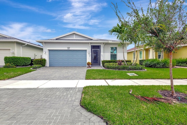 521 SE Plumeria Dr, Port Saint Lucie, FL 34984 - single story home with an attached garage, decorative driveway, stucco siding, and a front lawn