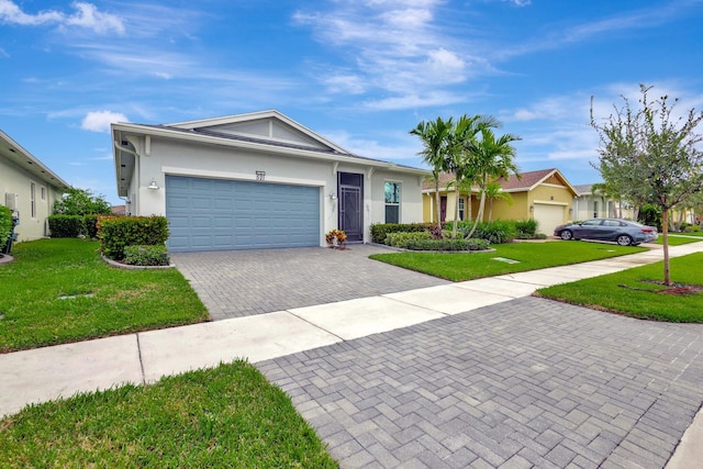 521 SE Plumeria Dr, Port Saint Lucie, FL 34984 - ranch-style home with a front lawn, an attached garage, decorative driveway, and stucco siding