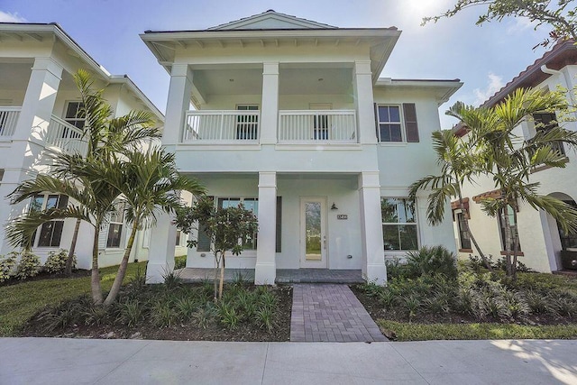 13496 Bernoulli Way, Palm Beach Gardens, FL 33418 - view of front facade featuring a balcony, stucco siding, and a porch