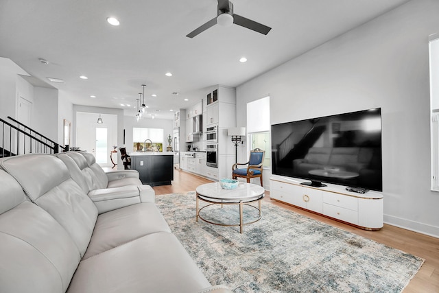 13496 Bernoulli Way, Palm Beach Gardens, FL 33418 - living room with recessed lighting, a ceiling fan, light wood-style floors, and stairs