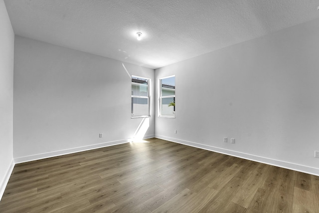 13496 Bernoulli Way, Palm Beach Gardens, FL 33418 - spare room featuring dark wood-style floors and a textured ceiling