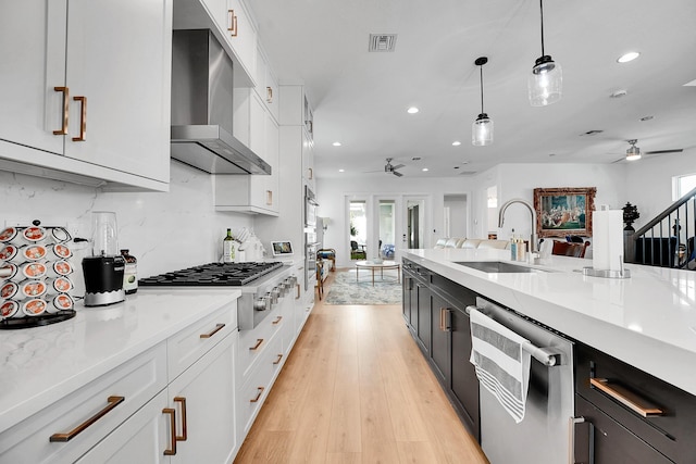 13496 Bernoulli Way, Palm Beach Gardens, FL 33418 - kitchen with a ceiling fan, appliances with stainless steel finishes, wall chimney range hood, white cabinets, and recessed lighting