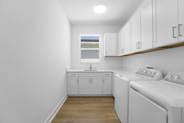 13496 Bernoulli Way, Palm Beach Gardens, FL 33418 - washroom featuring independent washer and dryer, light wood-style flooring, and cabinet space