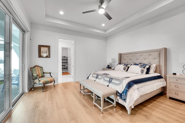 13496 Bernoulli Way, Palm Beach Gardens, FL 33418 - bedroom featuring multiple windows, access to exterior, a tray ceiling, light wood finished floors, and recessed lighting