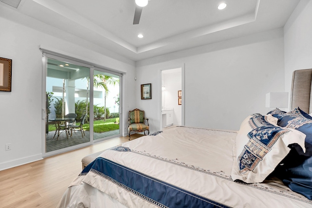 13496 Bernoulli Way, Palm Beach Gardens, FL 33418 - bedroom featuring access to outside, wood finished floors, a tray ceiling, recessed lighting, and ensuite bath