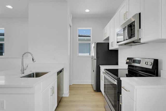 13496 Bernoulli Way, Palm Beach Gardens, FL 33418 - kitchen featuring stainless steel appliances, light wood-style flooring, white cabinetry, light countertops, and recessed lighting