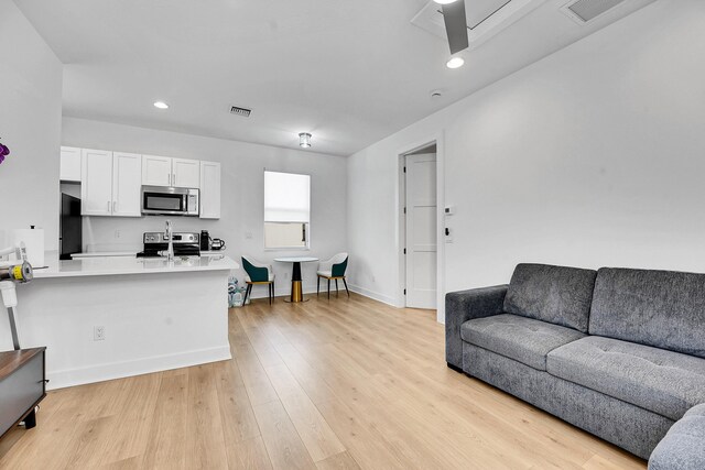 13496 Bernoulli Way, Palm Beach Gardens, FL 33418 - living room featuring light wood-type flooring and recessed lighting