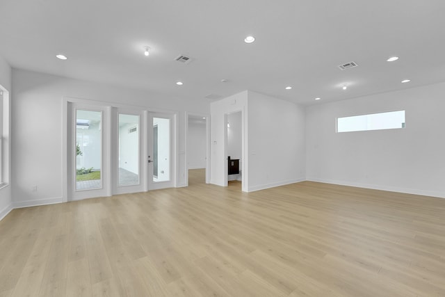 13496 Bernoulli Way, Palm Beach Gardens, FL 33418 - unfurnished living room with light wood-style flooring and recessed lighting