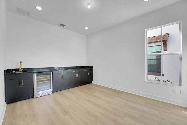 13496 Bernoulli Way, Palm Beach Gardens, FL 33418 - indoor wet bar featuring wine cooler, light wood-type flooring, and recessed lighting