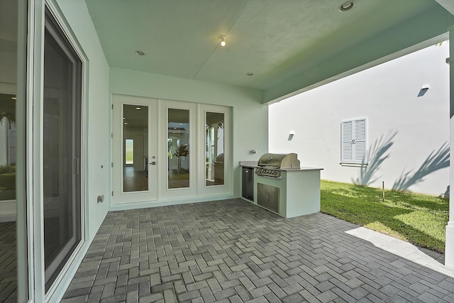 13496 Bernoulli Way, Palm Beach Gardens, FL 33418 - view of patio / terrace with exterior kitchen and french doors
