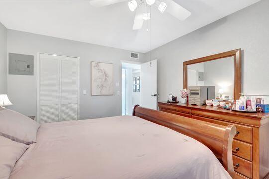 313 Saxony Unit G, Delray Beach, FL 33446 - bedroom with ceiling fan, electric panel, and a closet