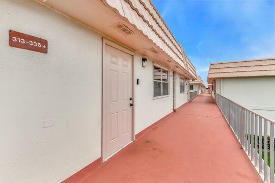 313 Saxony Unit G, Delray Beach, FL 33446 - view of exterior entry with stucco siding