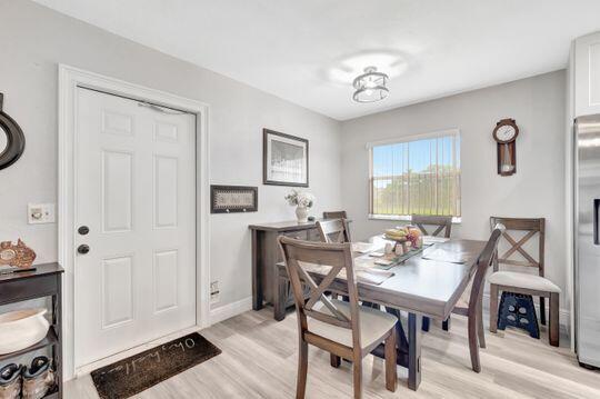 313 Saxony Unit G, Delray Beach, FL 33446 - dining room featuring light wood-type flooring and baseboards