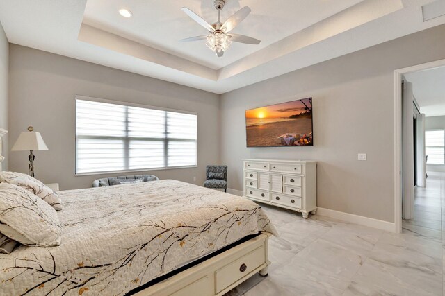 11535 SW Surf Springs Rd, Port Saint Lucie, FL 34987 - bedroom featuring a tray ceiling, light marble finish floors, and ceiling fan