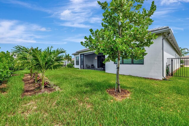 11535 SW Surf Springs Rd, Port Saint Lucie, FL 34987 - back of property with stucco siding, ceiling fan, and a sunroom