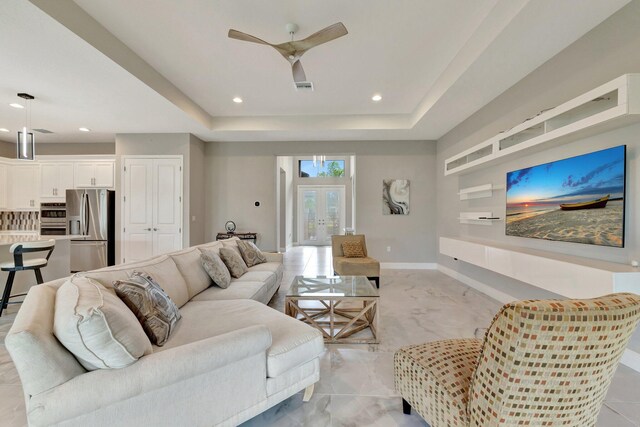 11535 SW Surf Springs Rd, Port Saint Lucie, FL 34987 - living room featuring a ceiling fan, recessed lighting, and a raised ceiling