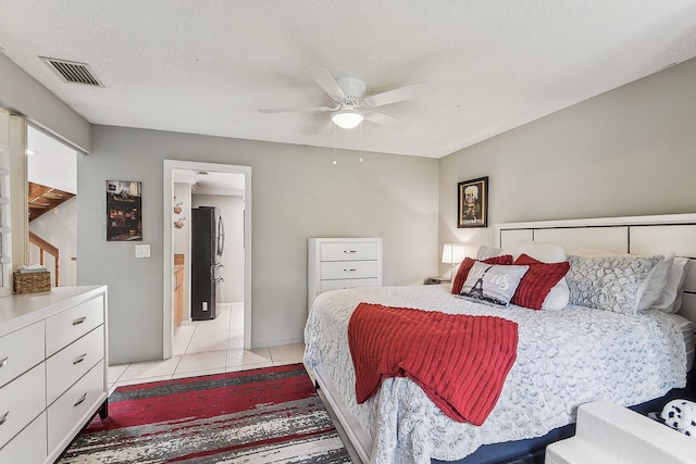 11063 Oakdale Rd, Boynton Beach, FL 33437 - bedroom with freestanding refrigerator, light tile patterned flooring, and ceiling fan