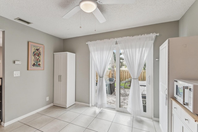 11063 Oakdale Rd, Boynton Beach, FL 33437 - unfurnished dining area with ceiling fan, a textured ceiling, and light tile patterned flooring