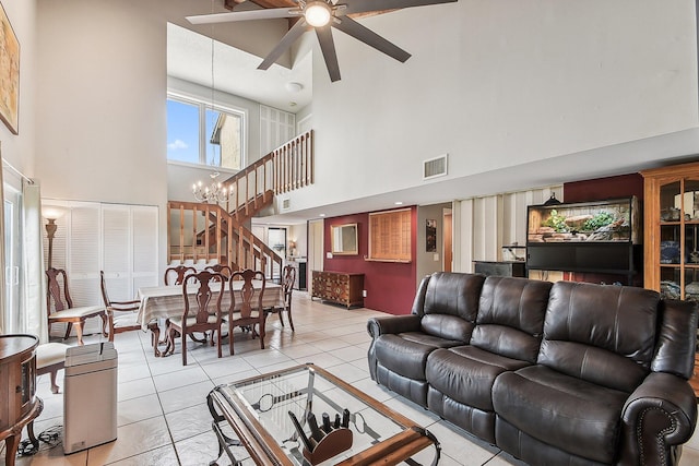 11063 Oakdale Rd, Boynton Beach, FL 33437 - living area with a towering ceiling, a ceiling fan, light tile patterned floors, a chandelier, and stairs