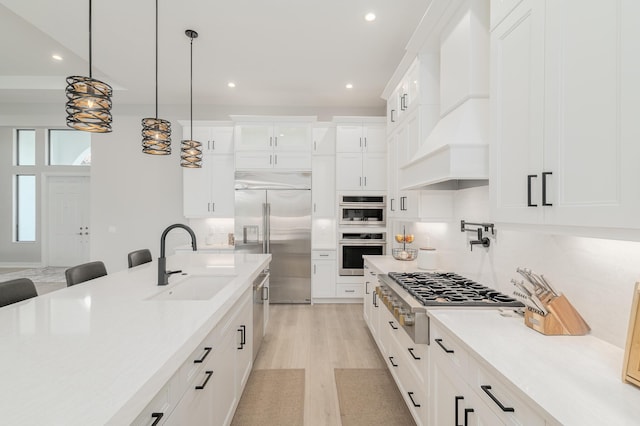 3153 SW Pond Apple St, Palm City, FL 34990 - kitchen featuring stainless steel appliances, custom range hood, light wood finished floors, recessed lighting, and light countertops