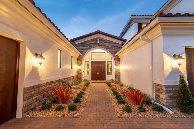 3153 SW Pond Apple St, Palm City, FL 34990 - doorway to property featuring stone siding, a tile roof, and stucco siding