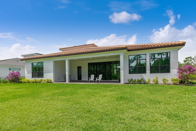 3153 SW Pond Apple St, Palm City, FL 34990 - back of house with stucco siding, a patio, and a yard