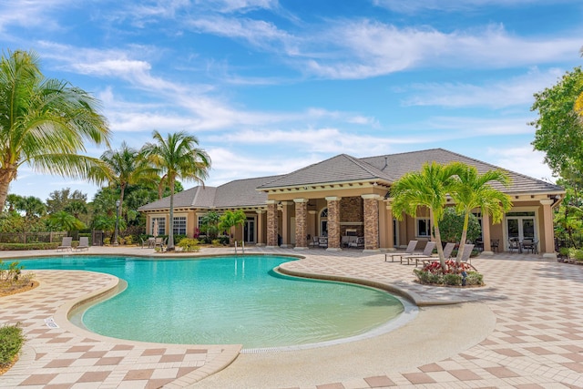 3153 SW Pond Apple St, Palm City, FL 34990 - community pool featuring a patio and french doors