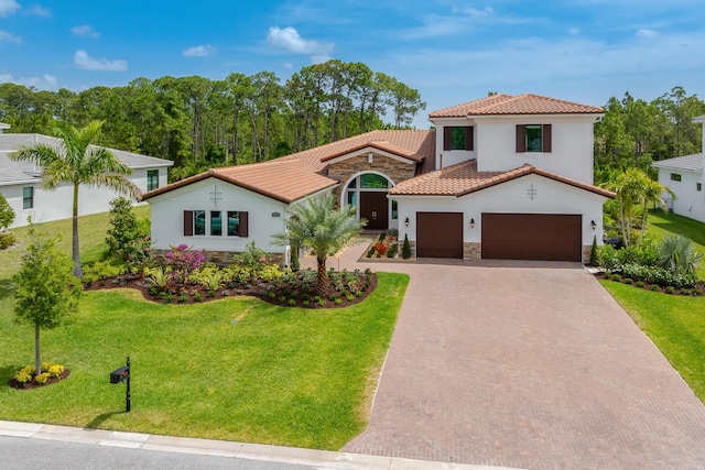 3153 SW Pond Apple St, Palm City, FL 34990 - mediterranean / spanish home featuring stone siding, a tile roof, decorative driveway, stucco siding, and a front yard