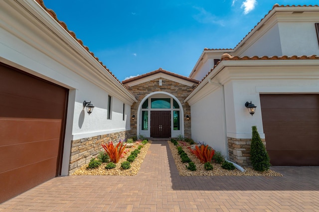 3153 SW Pond Apple St, Palm City, FL 34990 - property entrance featuring stone siding, stucco siding, and a tiled roof