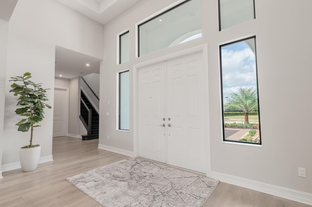 3153 SW Pond Apple St, Palm City, FL 34990 - entryway featuring healthy amount of natural light, stairway, light wood-style floors, and a towering ceiling