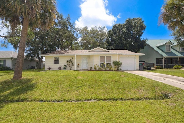 1967 SW Ember St, Port Saint Lucie, FL 34953 - view of front of property with an attached garage, driveway, and a front yard