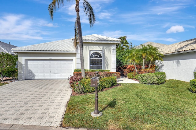 11857 Fountainside Cir, Boynton Beach, FL 33437 - view of front of house featuring a front yard, stucco siding, a garage, decorative driveway, and a tile roof