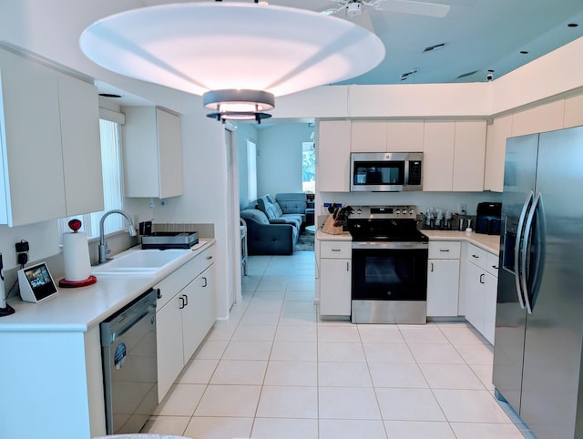 11857 Fountainside Cir, Boynton Beach, FL 33437 - kitchen with stainless steel appliances, light countertops, white cabinets, and light tile patterned flooring