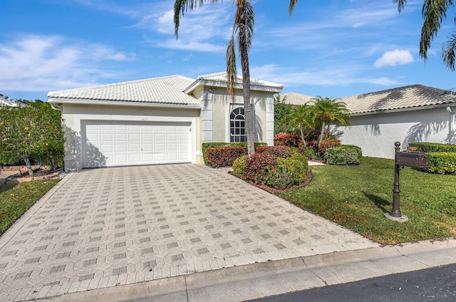 11857 Fountainside Cir, Boynton Beach, FL 33437 - view of front of property with a front lawn, an attached garage, driveway, and stucco siding