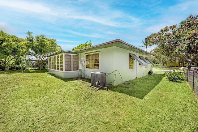 1606 16th Ave N, Lake Worth Beach, FL 33460 - view of home's exterior with a central air condition unit and a sunroom