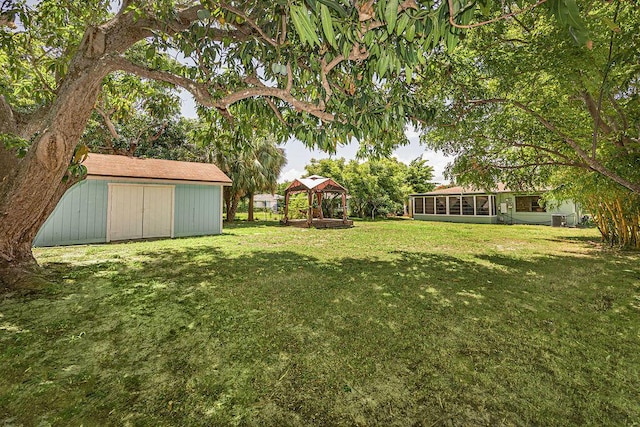 1606 16th Ave N, Lake Worth Beach, FL 33460 - view of green lawn featuring a gazebo, a storage shed, and a sunroom