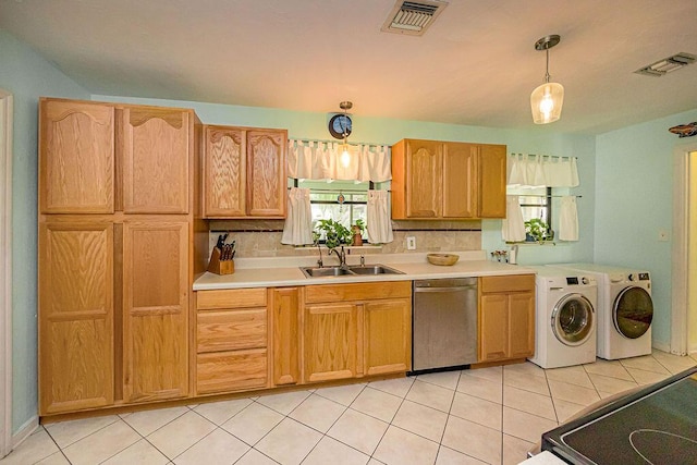 1606 16th Ave N, Lake Worth Beach, FL 33460 - kitchen with dishwasher, washer and clothes dryer, plenty of natural light, and light countertops