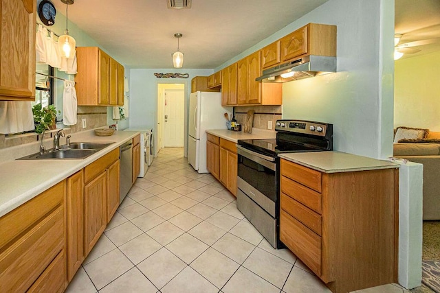 1606 16th Ave N, Lake Worth Beach, FL 33460 - kitchen featuring appliances with stainless steel finishes, under cabinet range hood, light countertops, and light tile patterned floors