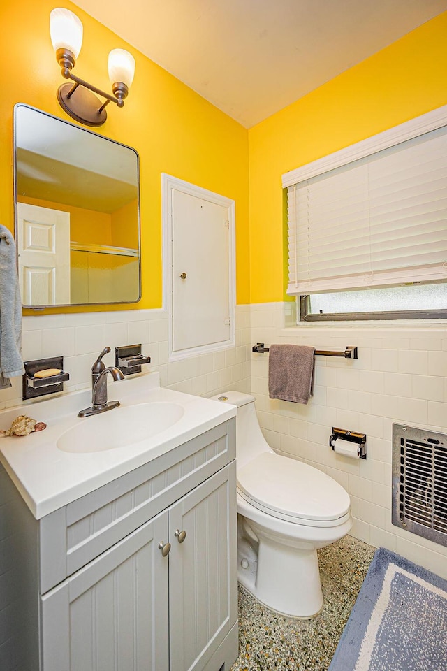 1606 16th Ave N, Lake Worth Beach, FL 33460 - bathroom with tile walls, vanity, a wainscoted wall, and speckle patterned floor
