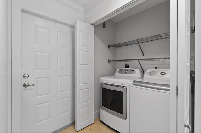 9850 Kamena Cir, Boynton Beach, FL 33436 - laundry area featuring washer and dryer, ornamental molding, and light tile patterned floors