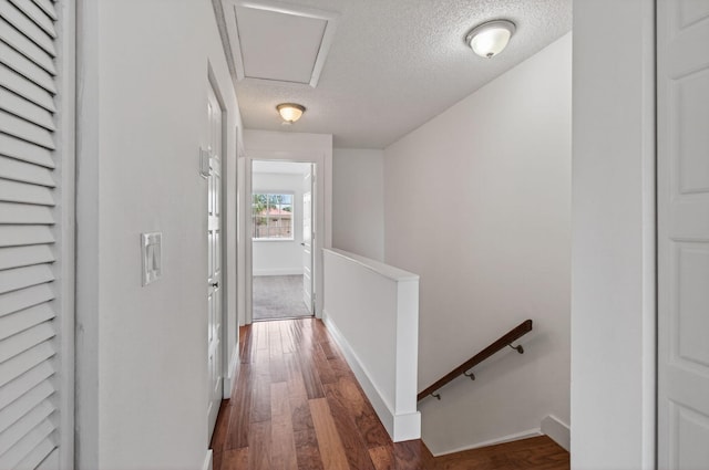9850 Kamena Cir, Boynton Beach, FL 33436 - hall with an upstairs landing, a textured ceiling, and dark wood-style floors