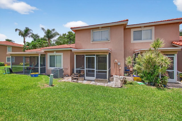 9850 Kamena Cir, Boynton Beach, FL 33436 - rear view of property with a sunroom, stucco siding, a tiled roof, and a lawn