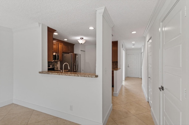 9850 Kamena Cir, Boynton Beach, FL 33436 - hall with light tile patterned floors, recessed lighting, a textured ceiling, and crown molding