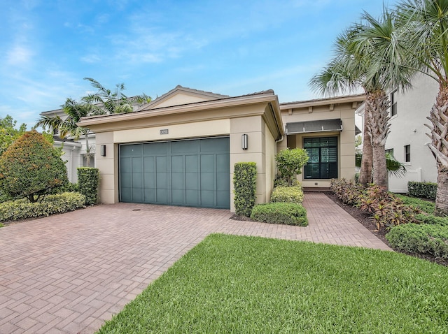13058 Artisan Cir, Palm Beach Gardens, FL 33418 - ranch-style house featuring stucco siding, a garage, decorative driveway, and a front lawn